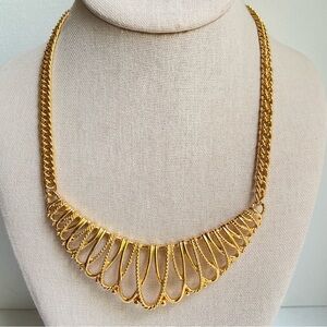 Avon vintage goldtone statement necklace with open loops on curved bar pendant